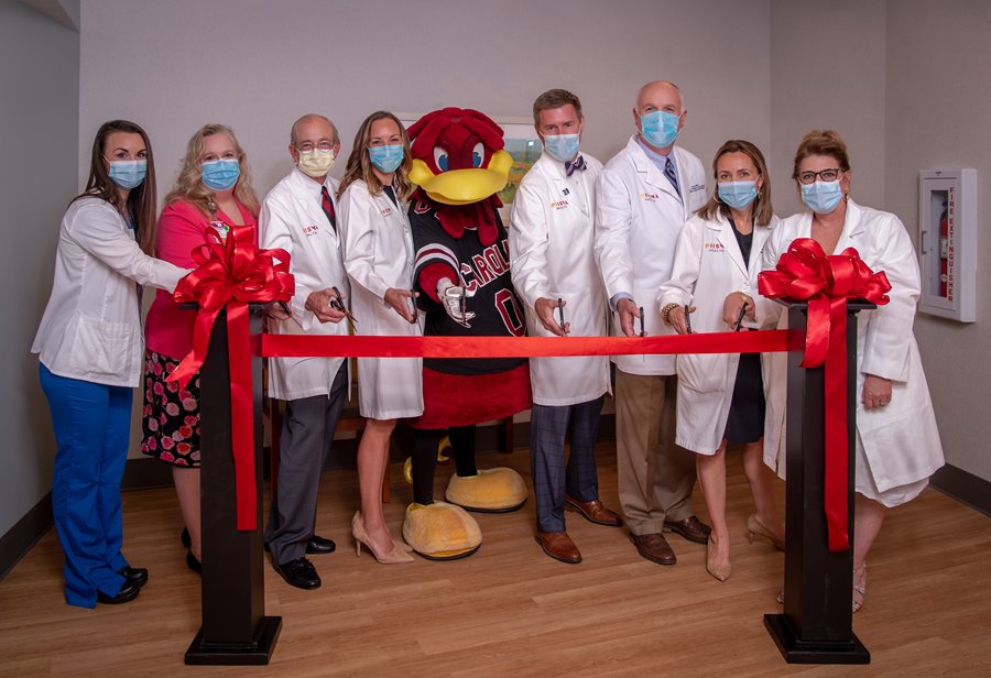 Prisma Health doctors and nurses pose at ribbon cutting for new fertility office in Columbia.